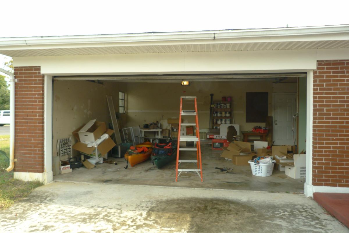 Cluttered garage full of junk waiting to be cleared